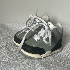 Nike Air Jordans size 2c. white, gray and black with green.